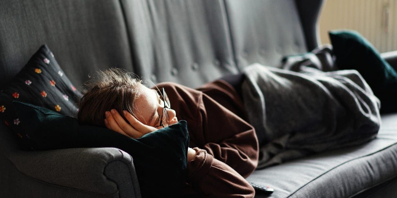 a woman lying on her couch